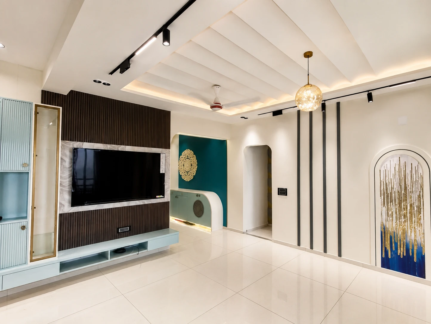 A finished foyer with teal wall treatment, concealed lighting, and a custom console.