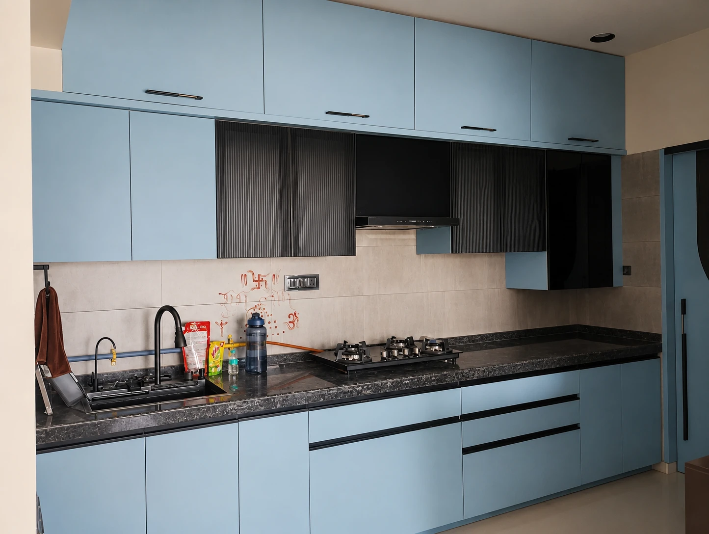 Modern kitchen with blue cabinetry and accents.